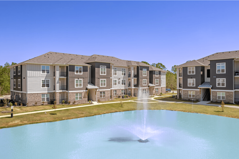 an image of an apartment building with a fountain